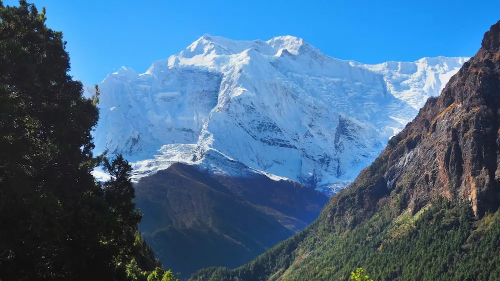 white-snow-mountain-through-hill